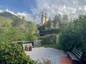 a garden with a building in the background with a church at Ferienwohnung Dallinger in Radmer an der Stube