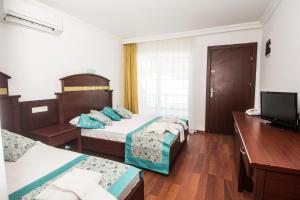 Postel nebo postele na pokoji v ubytování Sunberk Hotel