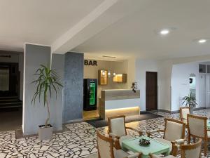 a bar in a hotel lobby with a table and chairs at Hotel Hefaistos - Sovata in Sovata