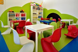 a childs play room with colorful chairs and tables at Iberostar Costa Dorada in San Felipe de Puerto Plata
