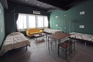 Postel nebo postele na pokoji v ubytování Tasogare Hostel