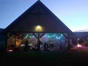 a group of people standing under a tent at night at Chata Otulina Radków - dom u podnóża Gór Stołowych in Radków