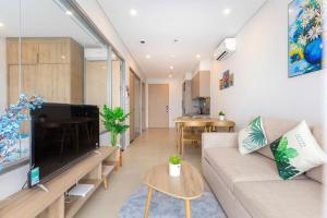 a living room with a couch and a flat screen tv at The sóng in Vung Tau