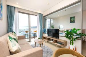 a living room with a couch and a television at The sóng in Vung Tau