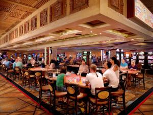 
a large group of people sitting at tables in a restaurant at TI - Treasure Island Hotel & Casino in Las Vegas
