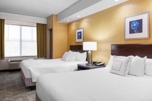 a hotel room with two beds and a window at SpringHill Suites by Marriott Wheeling Triadelphia Area in Wheeling +13 photos