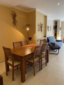 a dining room with a wooden table and chairs at Appartamento Sinestesia Oceanica in Puerto del Rosario