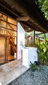 a house with a white refrigerator in a yard at La Casita Catangnan in General Luna