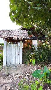 a small house with a straw roof at La Casita Catangnan in General Luna +3 photos