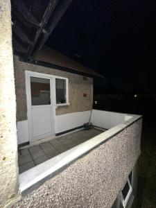 a white door on the side of a building at night at Smart and Chic 2 bed Apartment in London