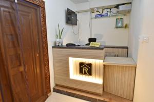 a reception desk in a room with a sign on it at Rubi Résidence in Pondicherry