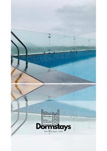 a picture of a swimming pool with its reflection in the water at Dormstays in Udaipur