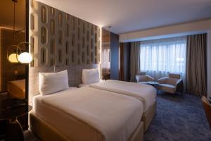 Tempat tidur dalam kamar di Nobel Design Hotel
