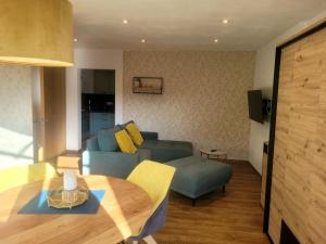 a living room with a couch and a table at Pension & Ferienwohnung Oberhof 810 M in Oberhof