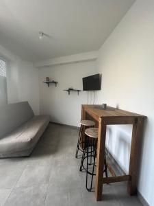 a room with a bed and a table and a tv at Appartement plein centre in Vierzon