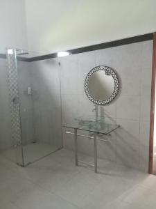 a bathroom with a glass table and a mirror at Villa Rosa east Bali in Karangasem