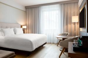 a hotel room with a large bed and a window at AC Hotel by Marriott Wroclaw in Wrocław