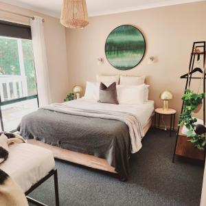 a bedroom with a large bed and a mirror at Eight Acres Lakes Entrance in Lakes Entrance