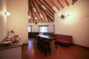 a living room with a table and a red couch at Plaza Medina Hotel in Sáchica +28 photos