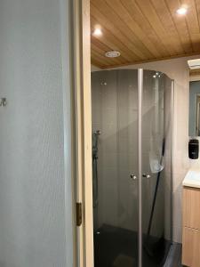 a shower with a glass door in a bathroom at Katinkulta Apartments in Vuokatti +18 photos