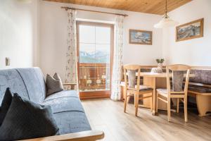 a living room with a couch and a table and a dining room at Prechtlhof in Flachau in Flachau