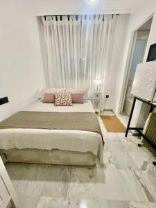 a bedroom with a large bed and a large window at Habitación Sierra Nevada in Cenes de la Vega