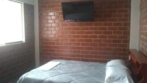 Ένα ή περισσότερα κρεβάτια σε δωμάτιο στο El Valle Lunahuaná