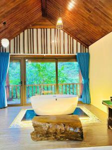 a large bathroom with a large tub in a room at Trạm Tấu Eco Garden Resort & Hot spring in Trạm Tấu