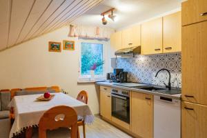 a kitchen with a table and a table and a dining room at Haus Kuchler in Bayerisch Eisenstein
