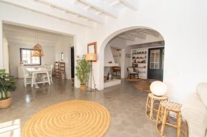 a white living room with a table and chairs at Finca Calafi Nou by Sonne Villas in Cala Galdana