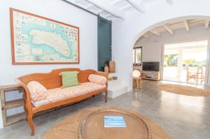a living room with a couch and a tv at Finca Calafi Nou by Sonne Villas in Cala Galdana