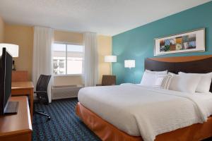 a hotel room with a large bed and a desk at Fairfield Inn & Suites Youngstown Boardman Poland in Poland +10 photos
