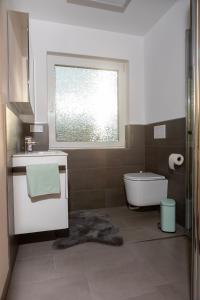 a bathroom with a tub and a sink and a window at Ferienwohnung MiA in Frankenau +15 photos