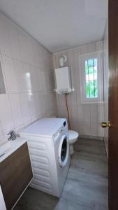 ein Badezimmer mit Toilette und Waschmaschine in der Unterkunft Villa Seaview in Santa Susanna
