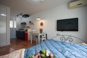 a bedroom with a bed with a tv on the wall at Pyeongchang Edelweiss Pension in Pyeongchang 