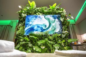 a large vase filled with plants and flowers at Costa Rica Bibione SPA in Bibione