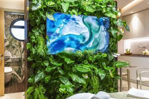 a wall covered in green plants in a room at Costa Rica Bibione SPA in Bibione