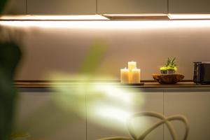 a counter with a candle and a plant on it at Costa Rica Bibione SPA in Bibione