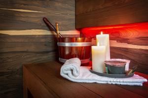 a candle and a candle holder on a table with a candle at Costa Rica Bibione SPA in Bibione
