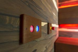 a switch on a wall with two red and blue lights at Costa Rica Bibione SPA in Bibione