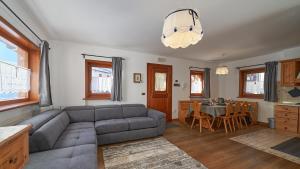 a living room with a couch and a table at Sweet Suite in Sappada