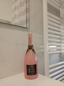 a bottle of wine sitting on top of a refrigerator at Casa Jasmine in Camporosso