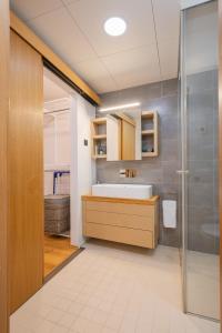 a bathroom with a sink and a shower at Modern city center apartment in Tartu +37 photos