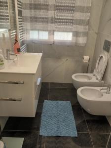 a bathroom with a toilet and a sink at Casa Jasmine in Camporosso +55 photos