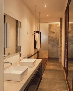 a bathroom with two sinks and a shower at Kara Fort Kochi in Fort Kochi