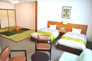 Postel nebo postele na pokoji v ubytování Hotel Familio Minakami