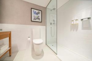 a bathroom with a toilet and a glass shower at Sheraton Buenos Aires Hotel & Convention Center in Buenos Aires