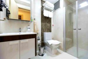 a bathroom with a toilet and a sink and a shower at A cozy smart home in Kusadasi Old Town in Kusadası