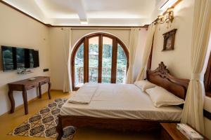 a bedroom with a large bed and a window at Ishaan Holiday Home in Nagaon +37 photos