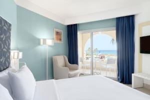 a hotel room with a bed and a view of the ocean at Iberostar Selection Diar El Andalous in Port El Kantaoui